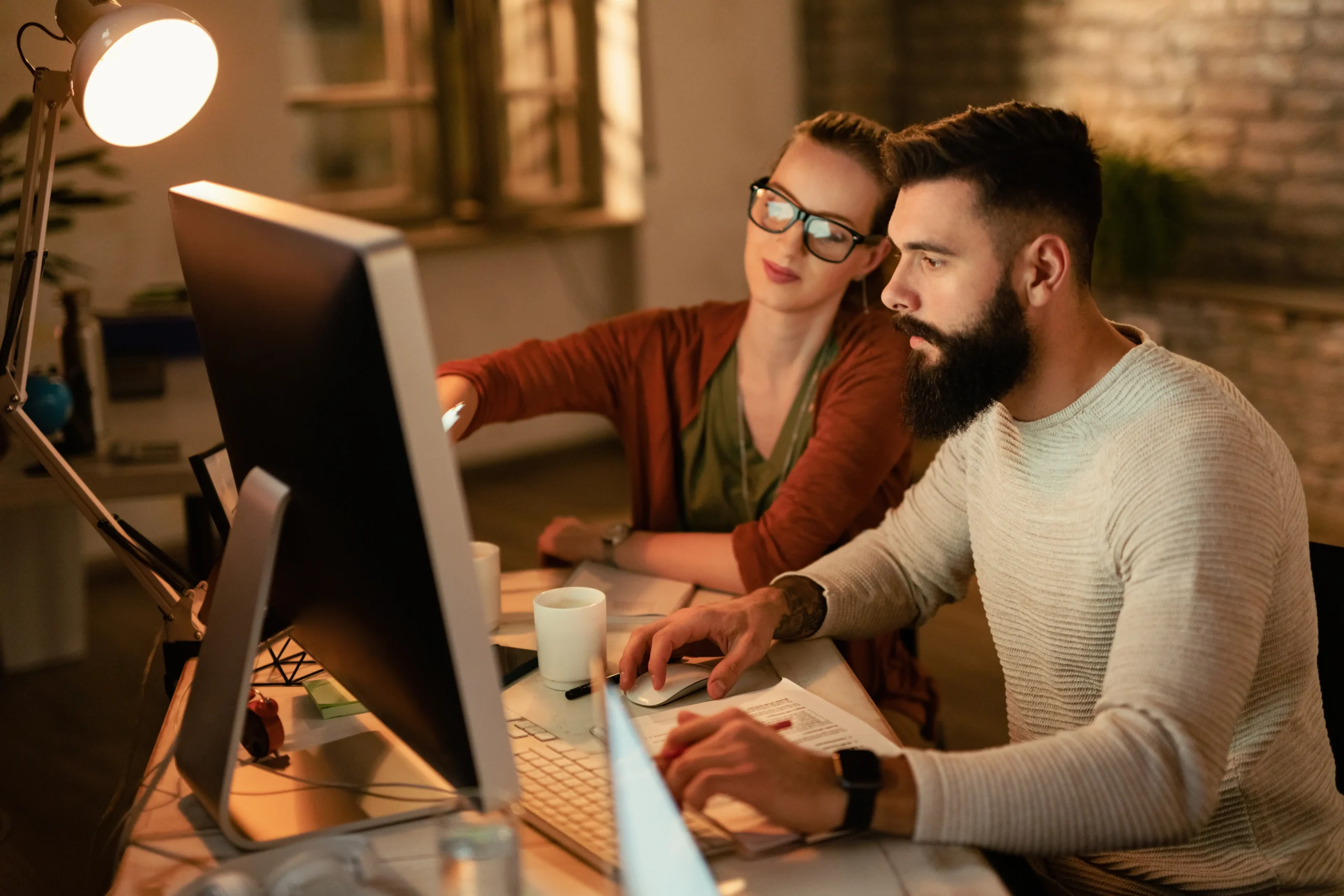 young-business-colleagues-using-computer-while-working-together-office